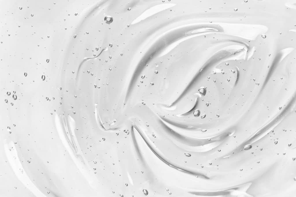 face serum or gel texture. clear skincare cream with bubbles bac